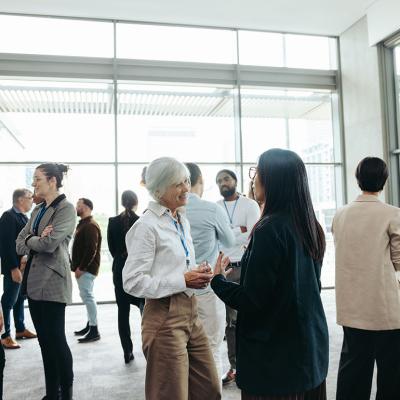 A diverse group of professionals networking at an event.