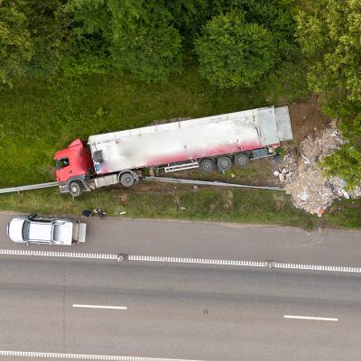 An aerial view of a truck accident scene on a highway.