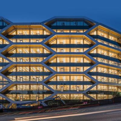 A night view of the 10-story mass timber office building known as The Hive located in Vancouver, British Columbia.