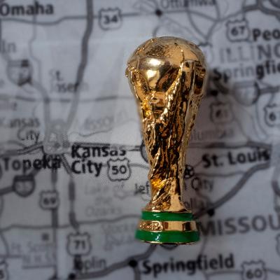 A miniature golden FIFA World Cup trophy on top of a map focused on Kansas City where the 2026 games will be held.