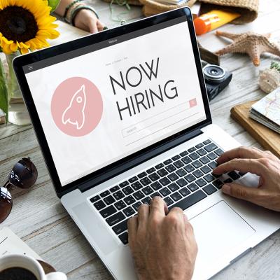 A person checking job opportunities online from a laptop. 