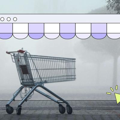A shopping cart sits alone on a foggy, misty street, framed inside an illustrated browser window with a purple scalloped storefront awning. A yellow cursor arrow points toward the bottom right corner of the browser frame.