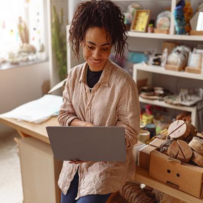 A decorator checking work online in her own art studio.