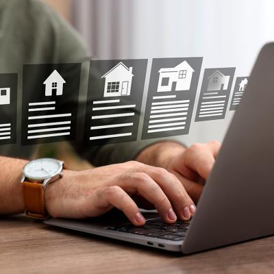 A person choosing residential home options from a laptop at home.