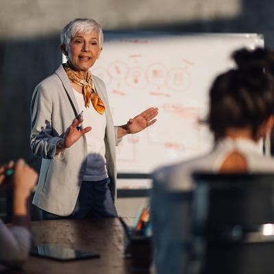 A female senior executive leading a team meeting.