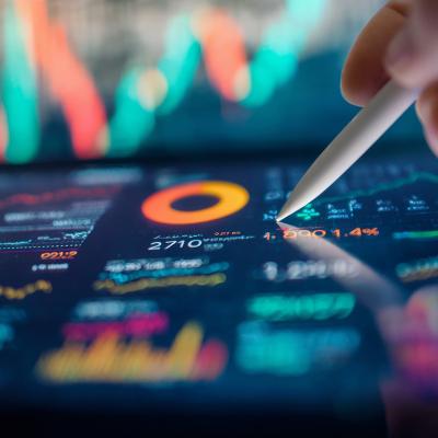 A smart pen navigating a finance dashboard displayed on a tablet.