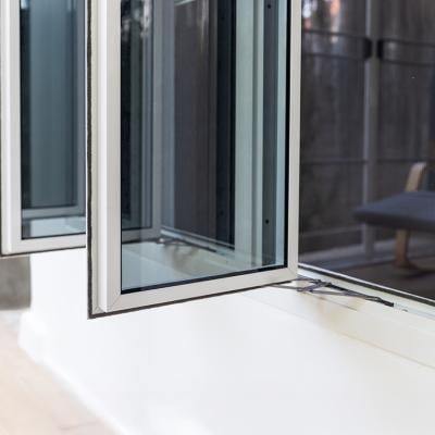 Three panel aluminum casement window installed in a home wall. 