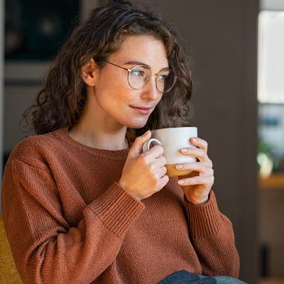 A person drinking coffee while relaxing at home.