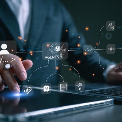 Agentic AI workflow graphics over a businessman using a laptop and tablet for productivity.