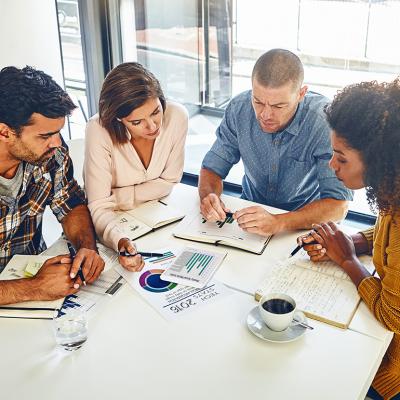 A team of designers engaged in a meeting in an office.