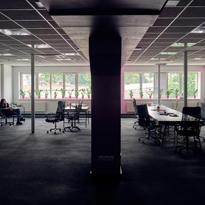 A female employee alone in a big office.