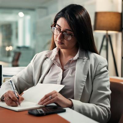 An employee planning schedules with a calendar for corporate activities at work.
