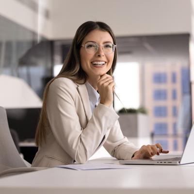 A female business executive happily looking at a presentation in an office.