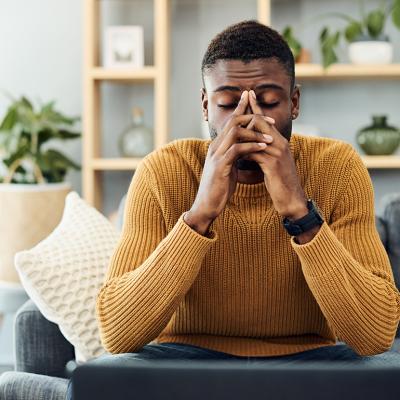 A person looking stressed out at home. 