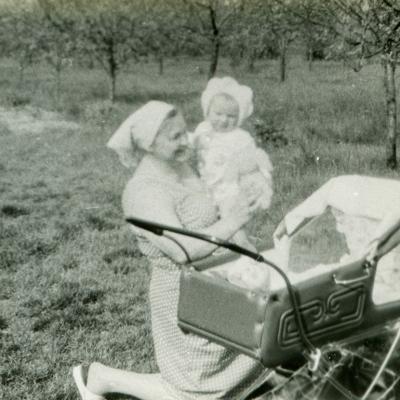 A vintage photo of a grandmother with her grandchild outdoors.
