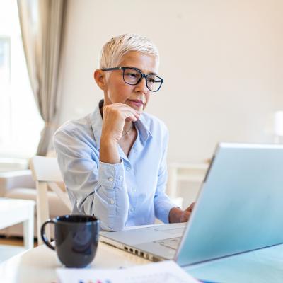 A middle-aged businesswoman working from home.