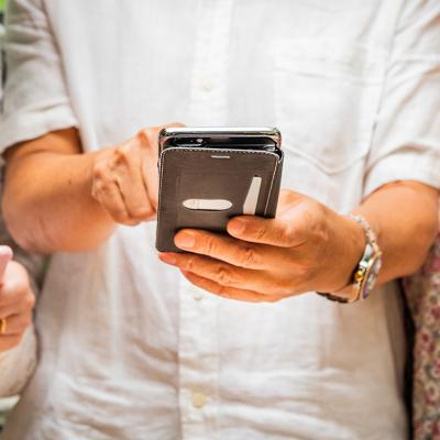 People using and sharing their smartphones' content with each other.