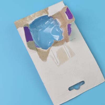 A torn cardboard and plastic packaging.