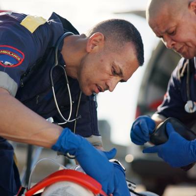 Paramedics attend to a road accident victim.