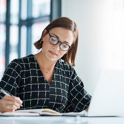 An office employee drafting a proposal for a stakeholder organization.