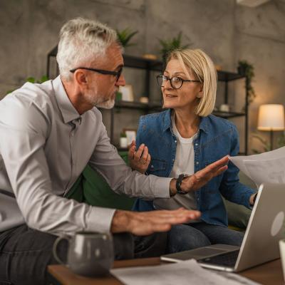 An elderly couple discussing over their estate plan's documents at home. 