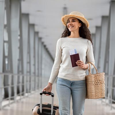 A traveller walking her way to the airport's departure gate. 
