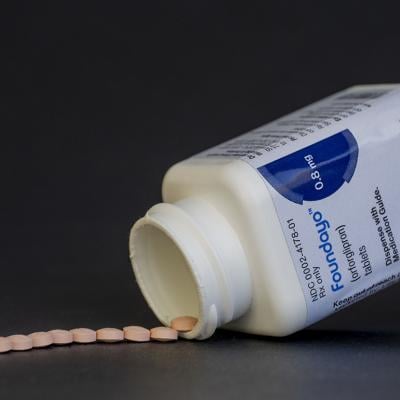 Foundayo weight loss pills neatly spilled from its bottle.