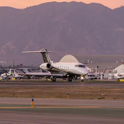 A Bombardier Challenger 3500 aircraft landing on runway in Van Nuys Airport in California.