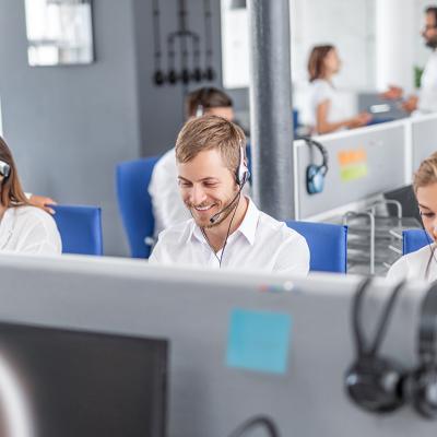 A row of call center workers at work.