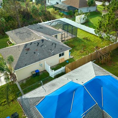 Aerial view of a house's roof damaged by Hurricane Ian in Florida.