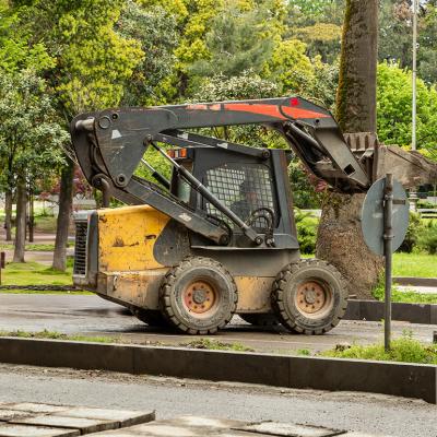 A skid steer loader operating on the park.