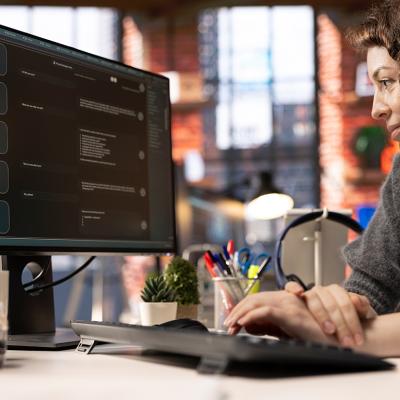A female employee navigating an AI chatbot system for work.