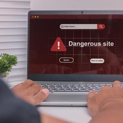 A dangerous site warning displayed on a laptop.
