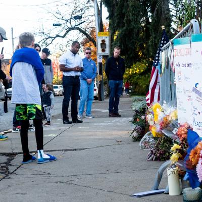 People gathering and paying their respects at a memorial, one year after the shooting at the Tree of Life synagogue in Squirrel Hill, Pittsburgh, USA.
