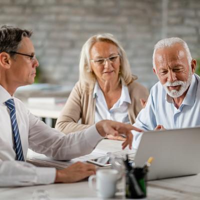 A senior couple having a meeting with a financial advisor.