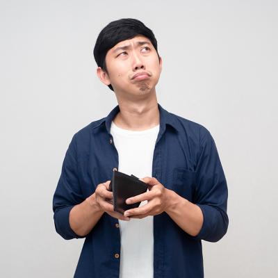 A frugal man confusingly holding an empty wallet.