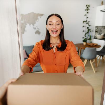 A happy woman receiving a package.