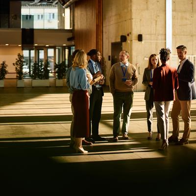 A group of entrepreneurs engaged in discussion at a conference venue.