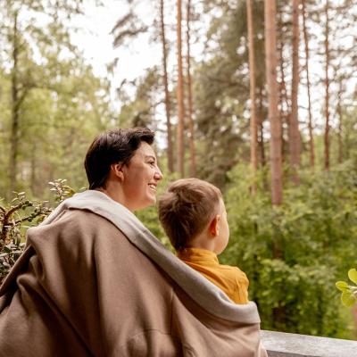 A grandmother enjoying outdoor view with her young grandson.