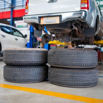 A stack of used tires in an auto repair shop.