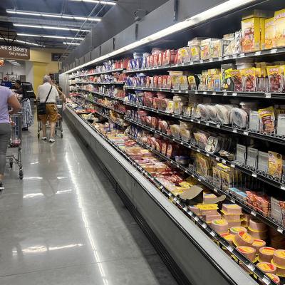 Customers shop in the deli meat aisle of a grocery store in Miami, Florida.