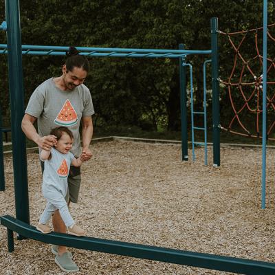 A father and his son bonding together in a playground.