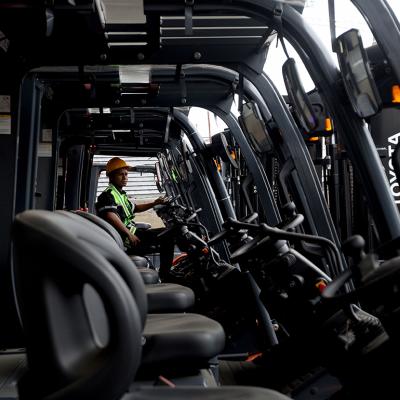 An operating trying out a new electric forklift.