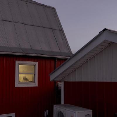 A worker can be seen by the window of one of the dairy farm properties at Pleasant Valley Farms in Vermont.