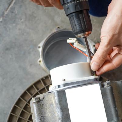 A repairman removing servo electric motor in a workshop.