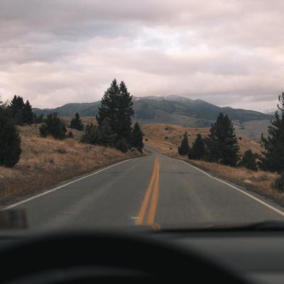 A scenic highway with a mountainous terrain in the distance.