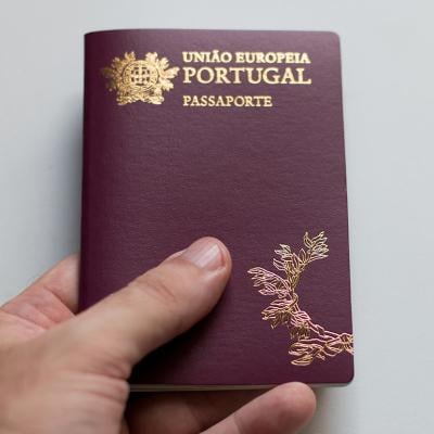 Person holding a Portuguese passport.