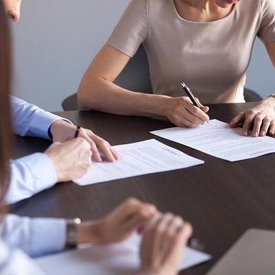 New business partners fill out a document form.