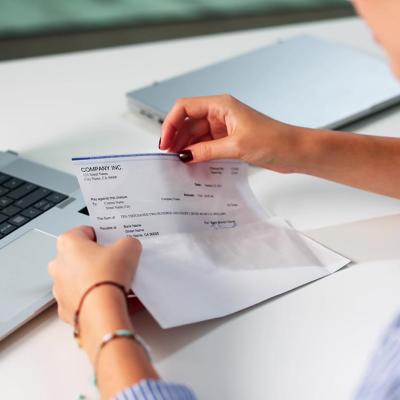 A payroll officer reviewing a compensation check.