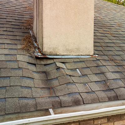 A roof's shingles damaged from a water leak.